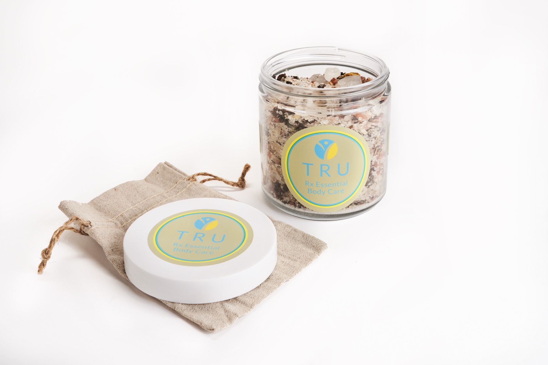 TRU Rx bath salts in a clear jar with linen sachet