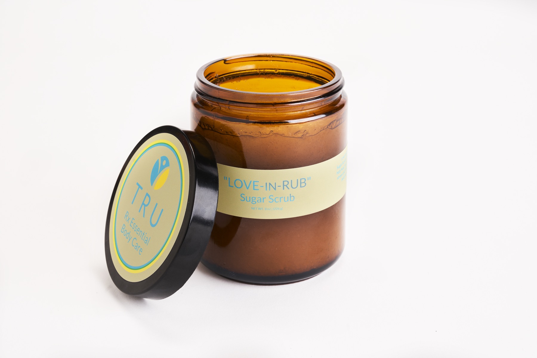 Love-In-Rub sugar scrub in an amber glass jar