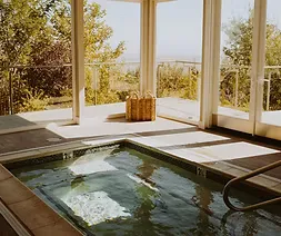 Spa soaking room with open windows and natural light
